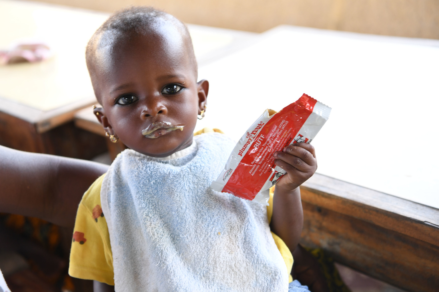 A child is eating peanut paste