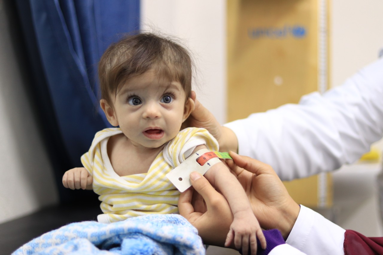 Baby Jana is assessed for malnutrition using a MUAC band at a UNICEF supported health center in Aleppo Syria