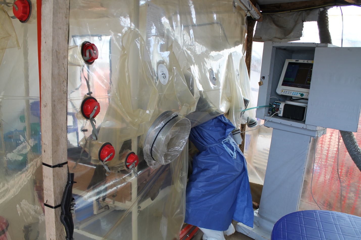 Doctor treats Ebola patient at Treatment Centre in Beni, DRC