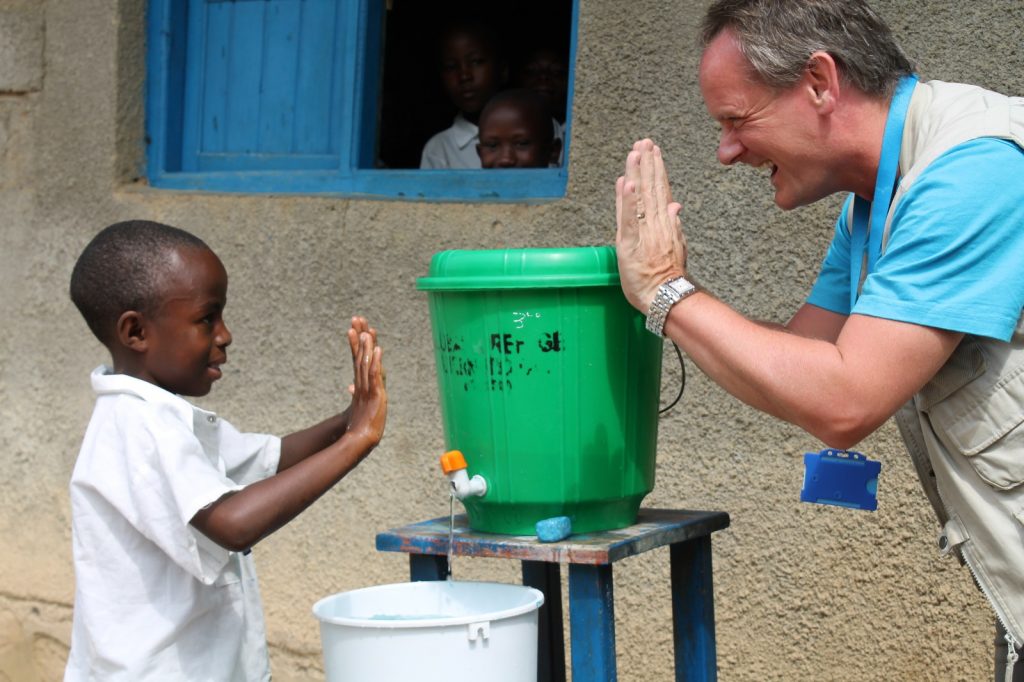 A Man is clapping hands with a young boy 