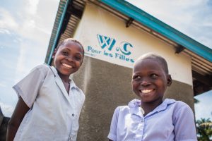 Students stand outside newly build toilets