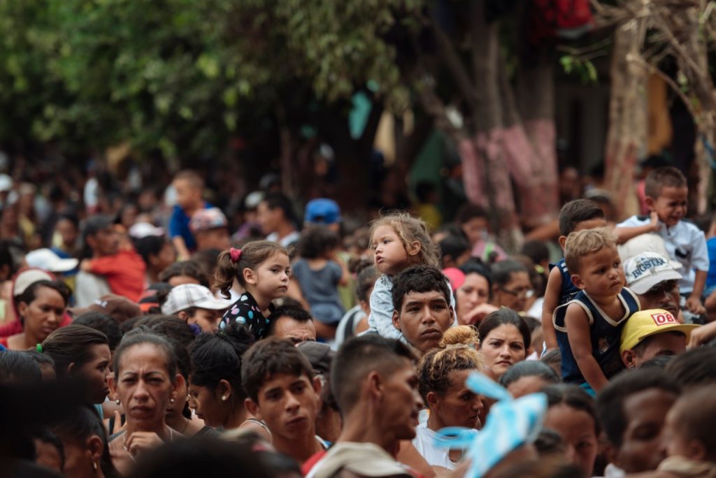 A group of migrants are walking carrying children