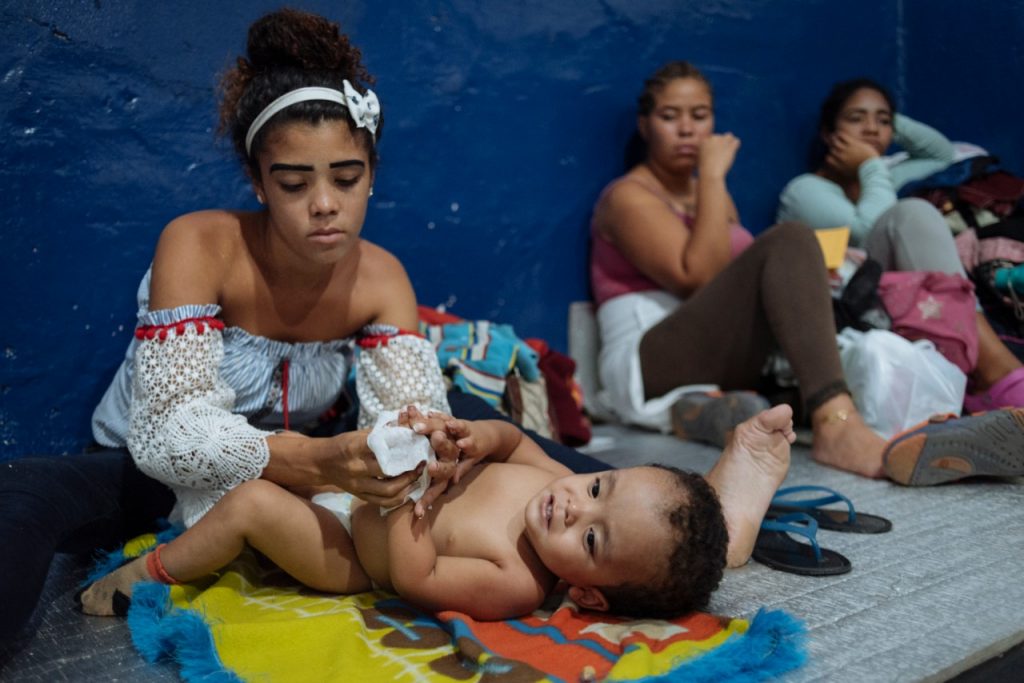 A mother plays with her baby 