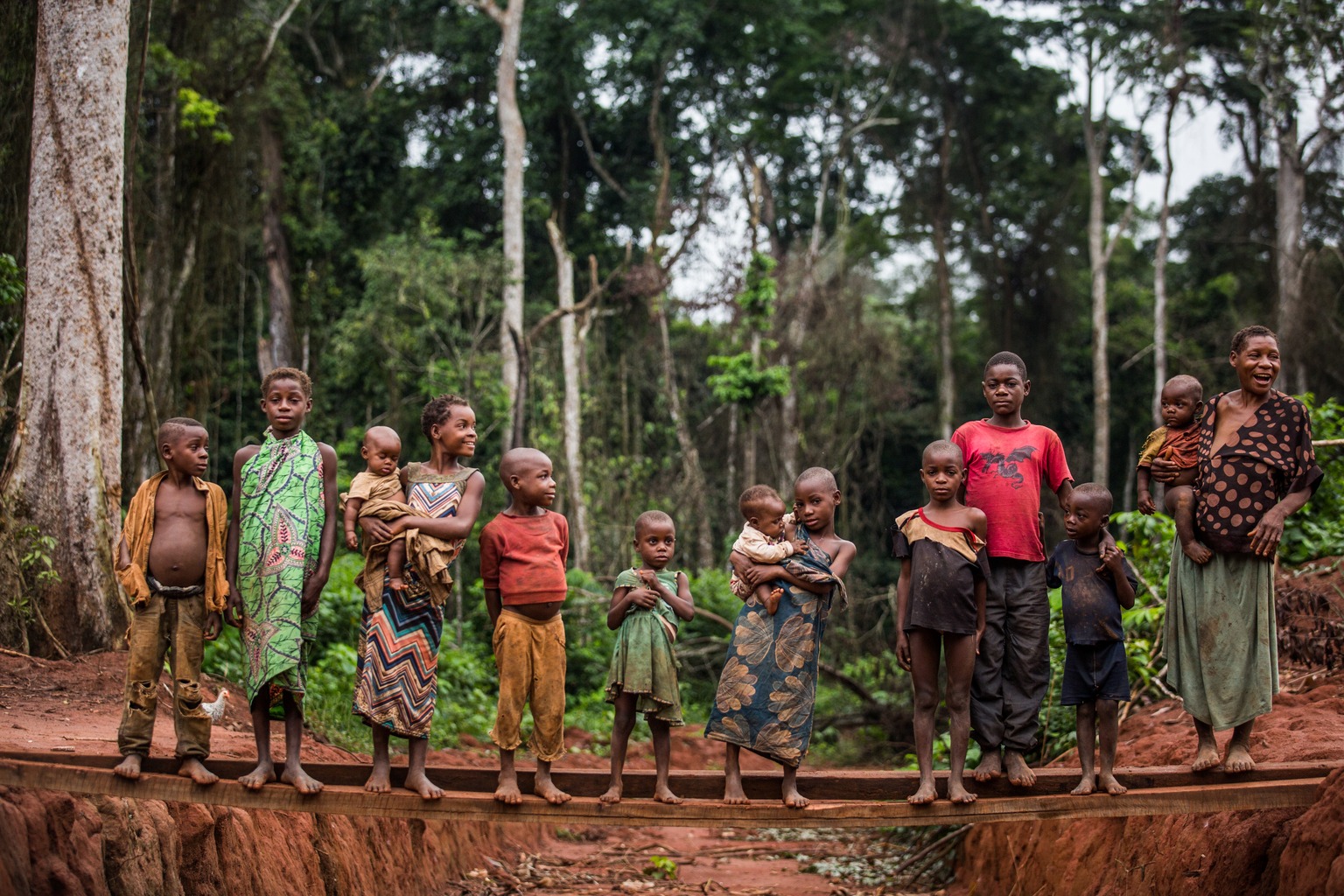 a group of children is standing on a bridge