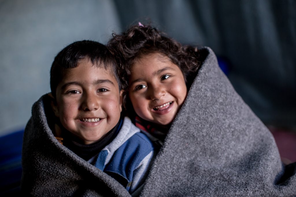 children wrapped in blanket