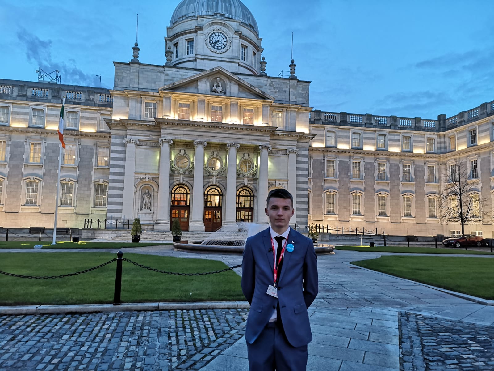 a teenage boy is posing in front of a government building