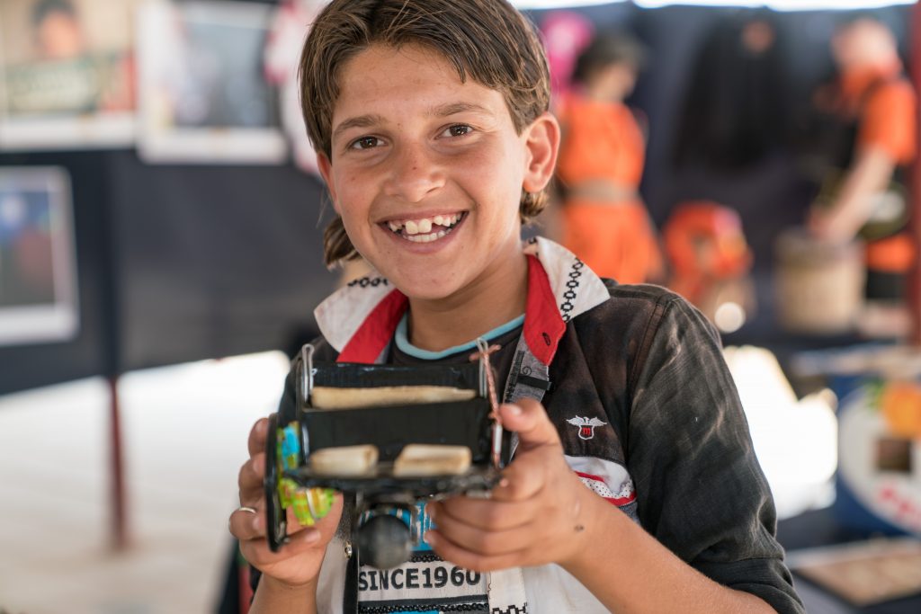 A child is playing with a robot