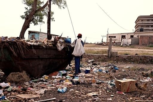 a man standing near a ship wreck