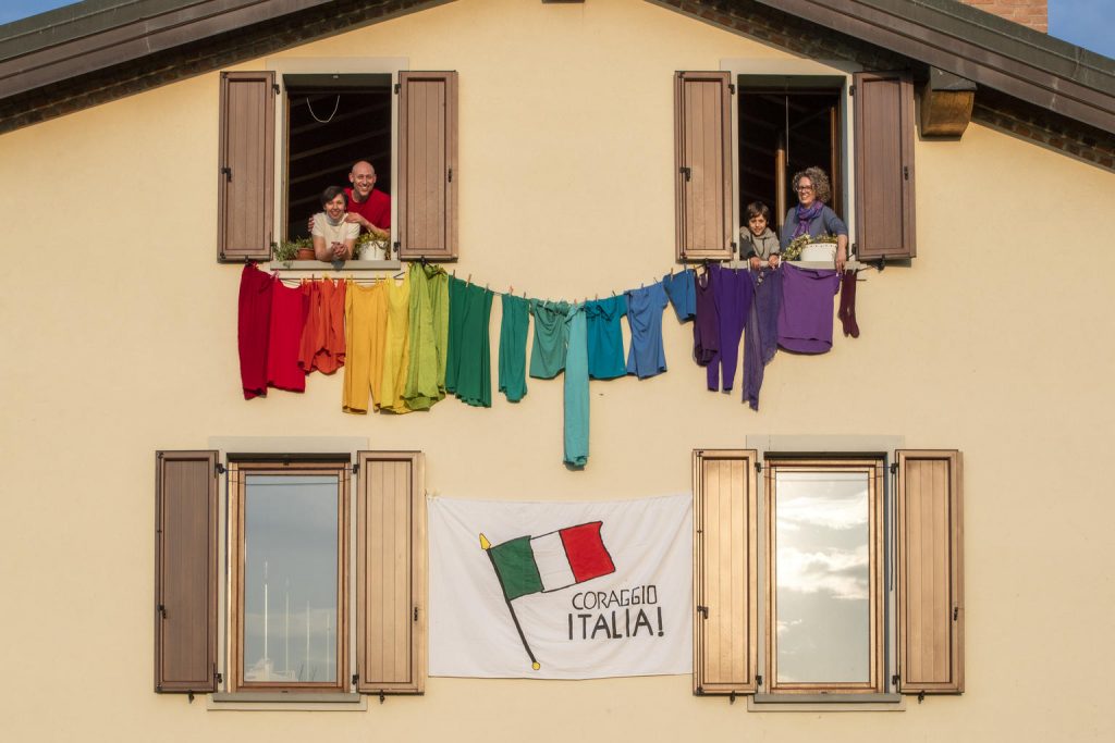 a family is handing colored clothes by the window