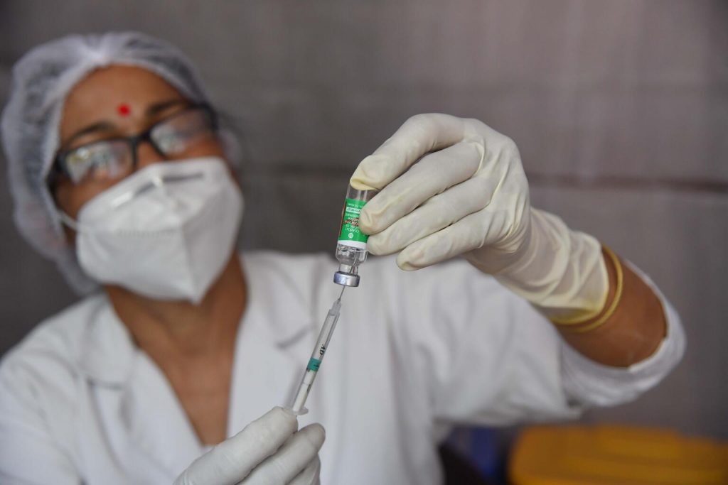 health worker prepares dose of covid vaccine