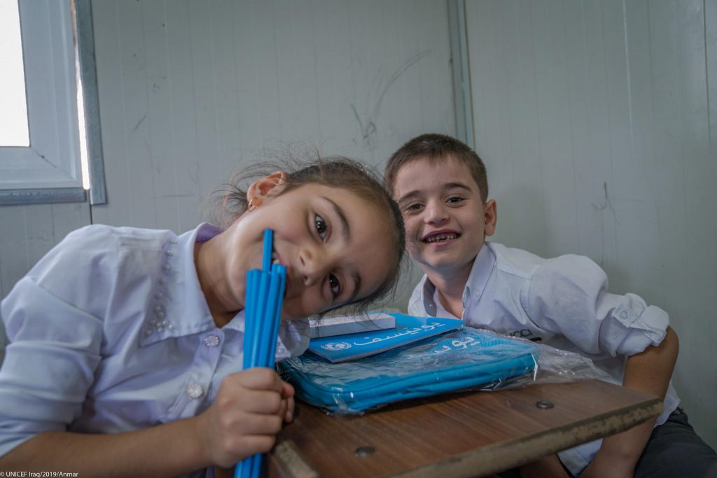 iraqi school children smile at camera