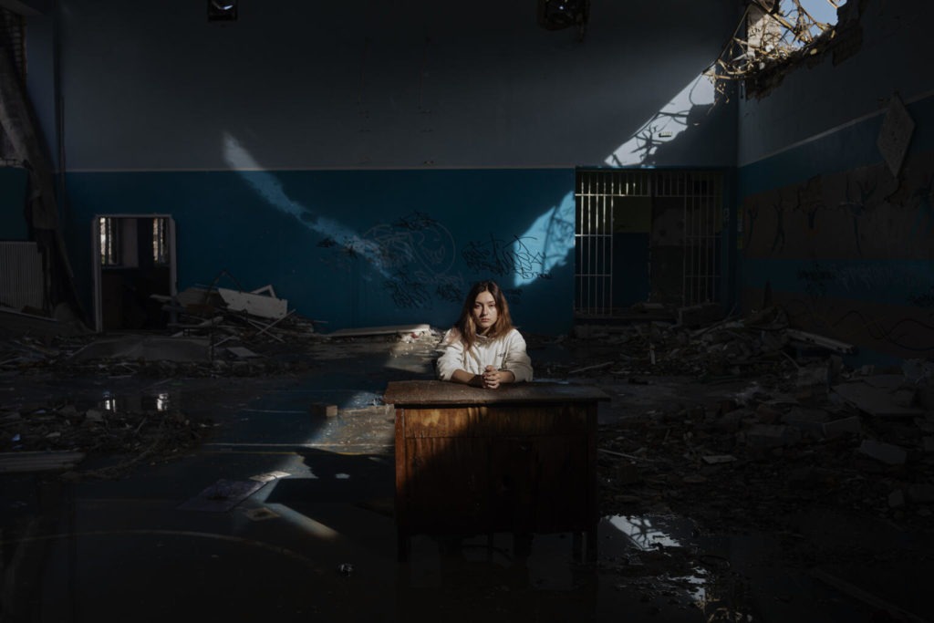 child sits in darkened classroom