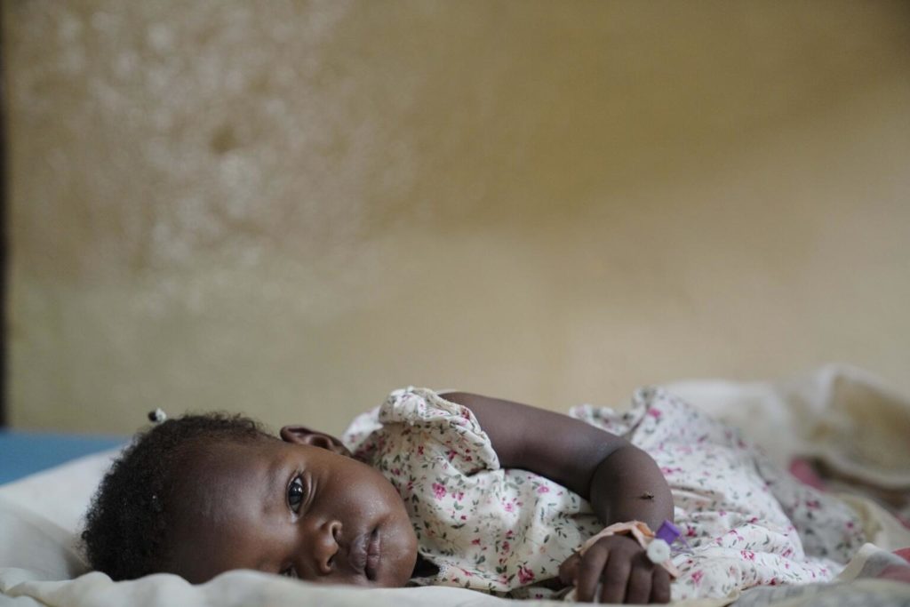 child lies on bed