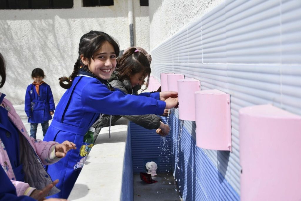 syrian girl washes hands