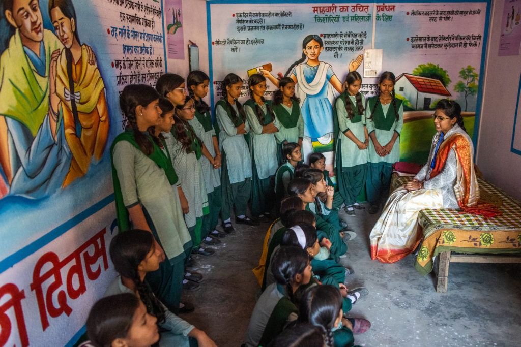 girls listen attentively to teacher