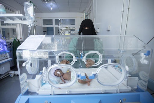 a new born baby is in an incubator
