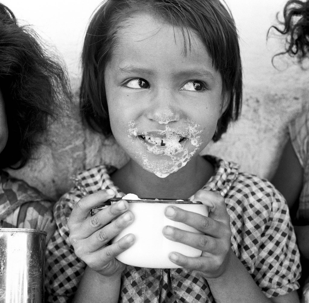girl drinks milk provided by unicef