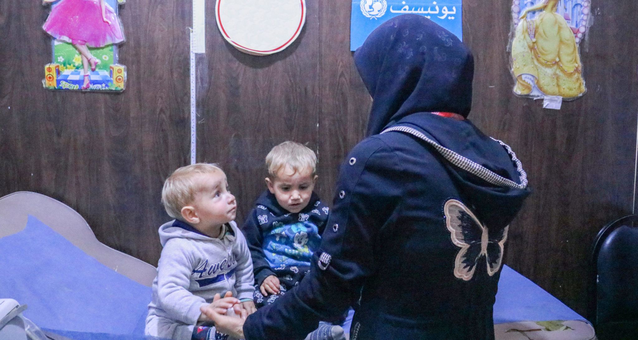 Abd, 3, his sister Malak, 1, and their mother Manal at a UNICEF-supported health centre in Aleppo, Syria.