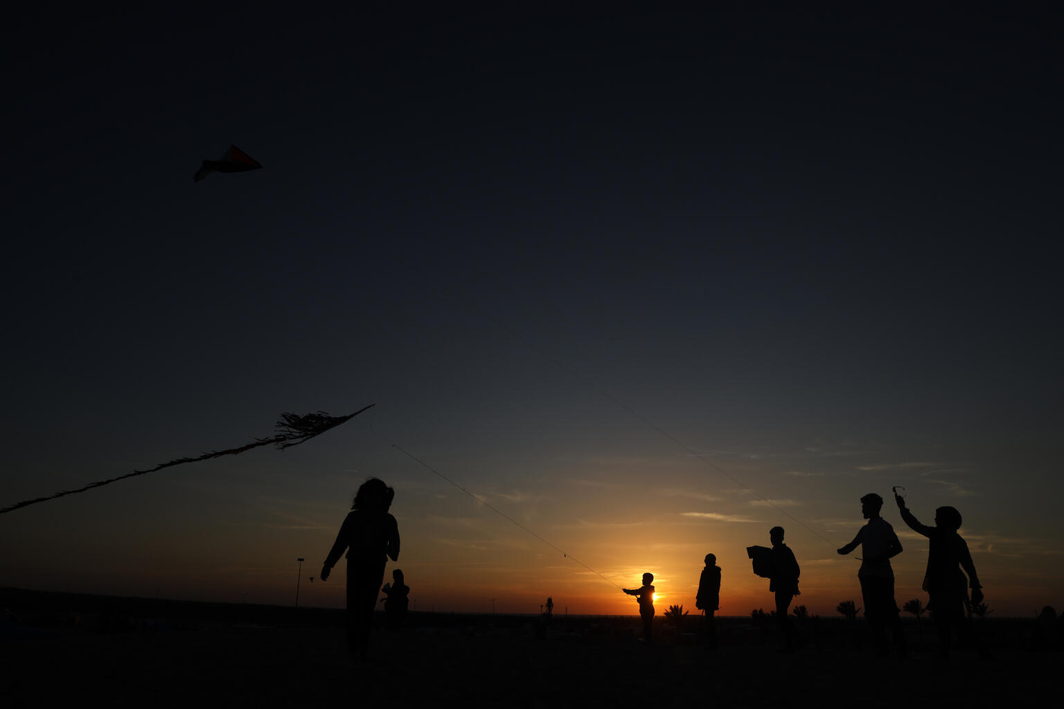 children playing while sun sets