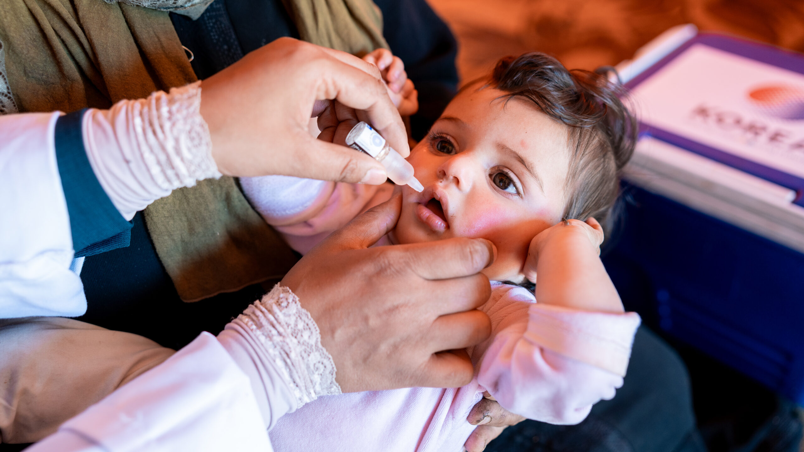 baby receives oral vaccination