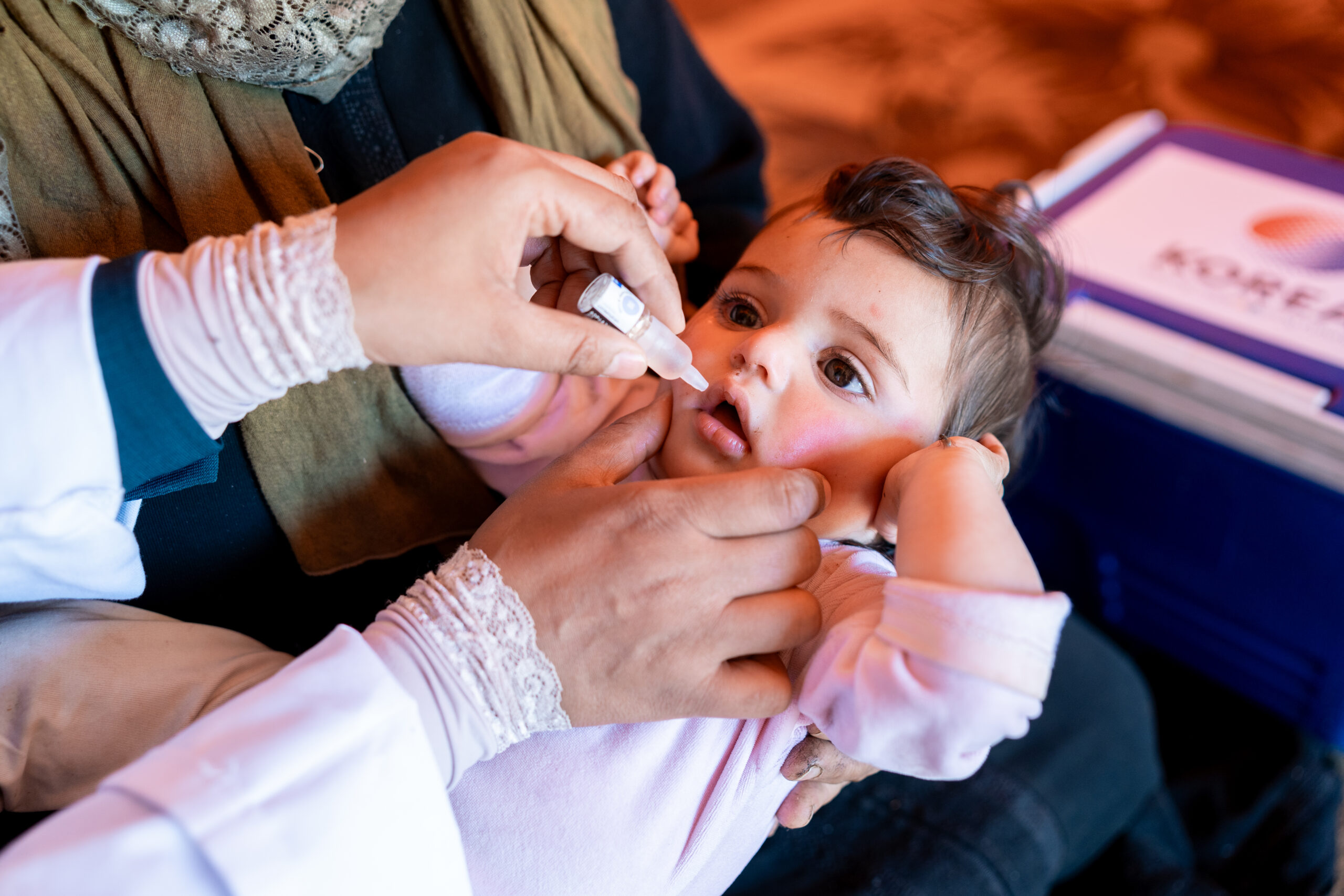 baby receives oral vaccination