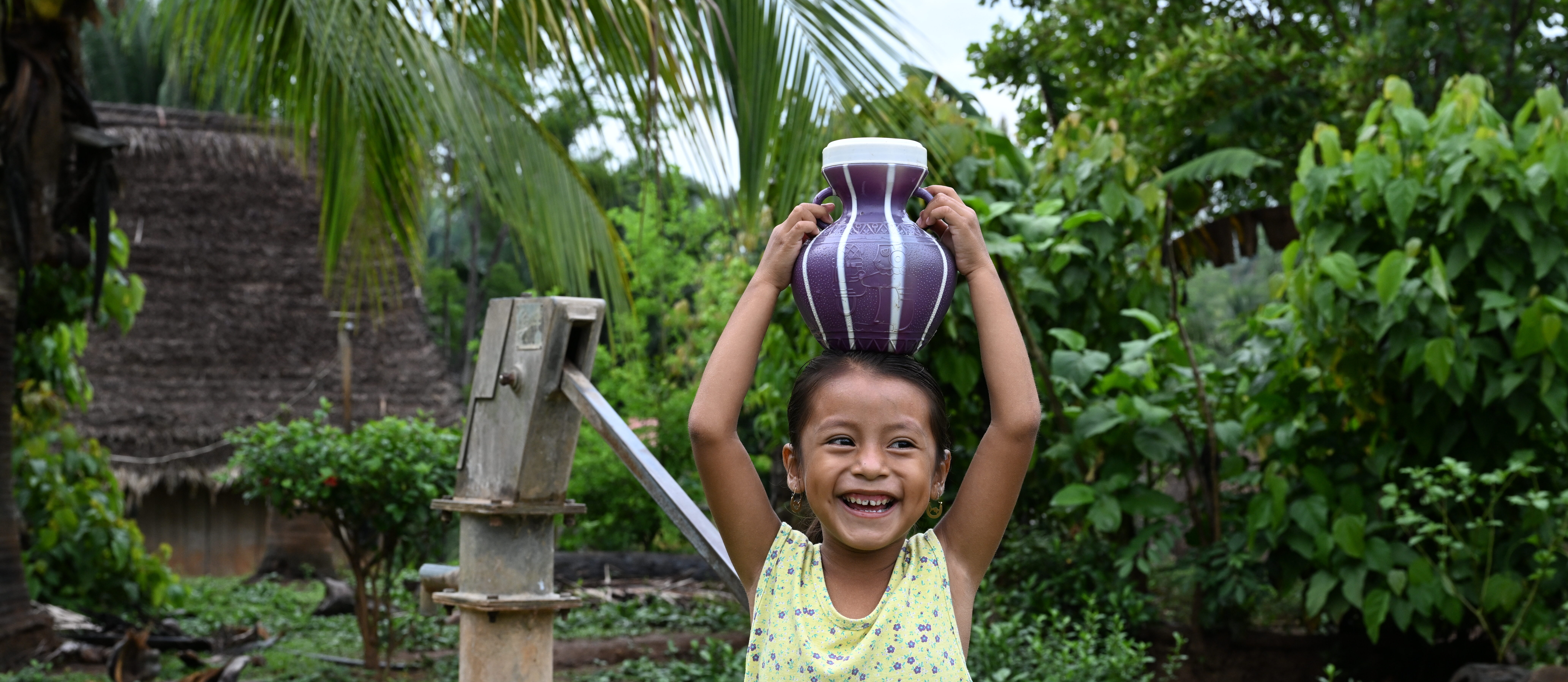 girl carrying jug of water on head