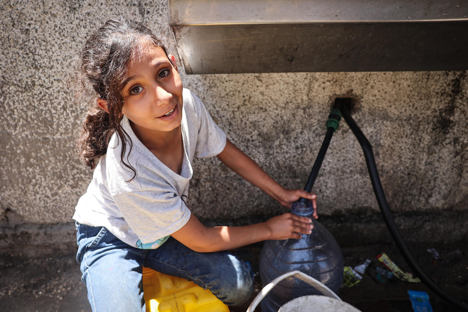girl fills bottle with water