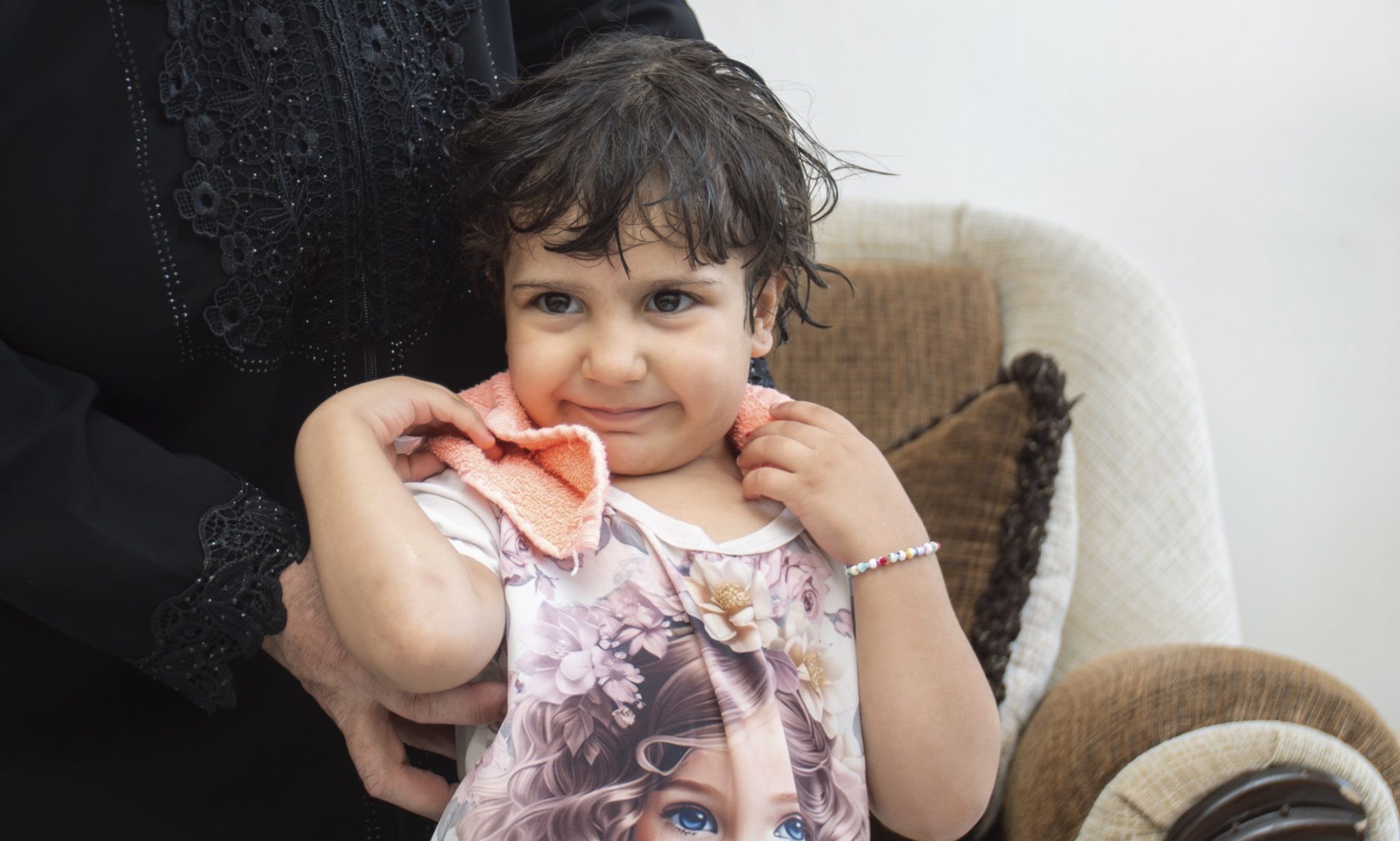 Shams, 4, has her hair dried by her grandmother Leila. She is only able to shower every 10 days due to water shortages.