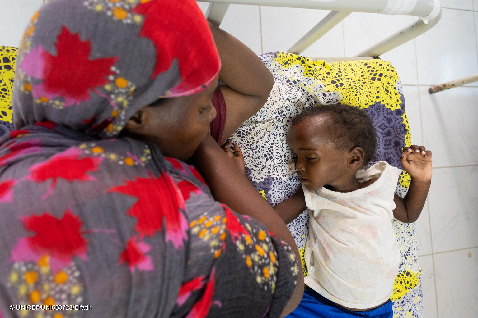 A mother cares for her son who is suffering from malnutrition at a health centre. UNICEF supporters provided therapeutic milk and ready-to-use-therapeutic food for children being treated at the clinic.