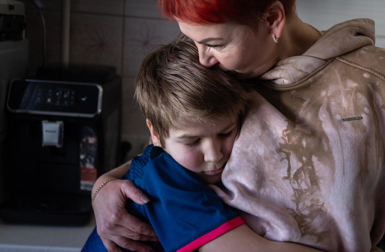 10-year-old Andrii hugs his mother in Kherson – a Ukrainian city that has been ravaged by conflict for 11 years. Andrii lost his father last winter, and now has to navigate a life filled with conflict without him. “I really don’t like living without Dad,” he said. “But mum tries to make sure I’m okay. And I try to support her.