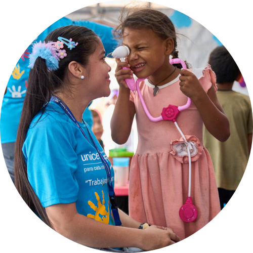 girl and unicef worker play together