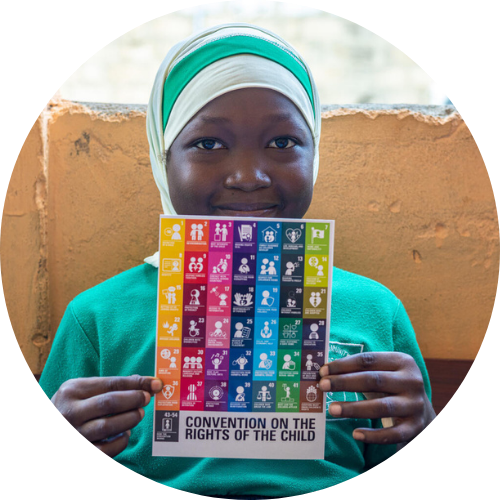 Girl holds up UN card
