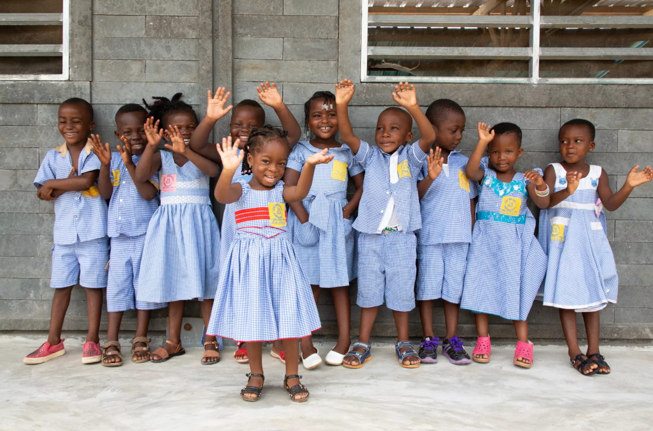 school children waving to camera