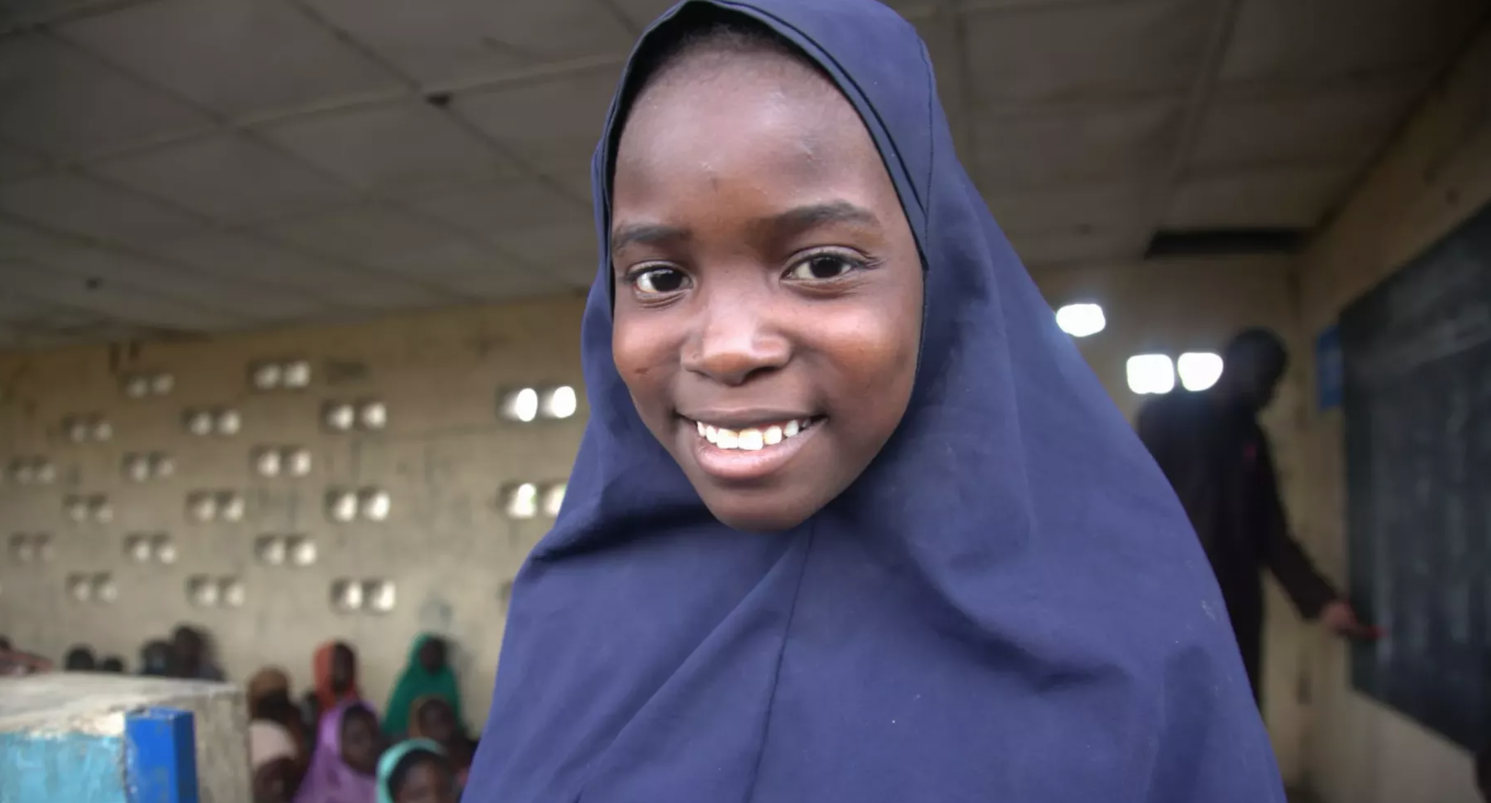 girls smiles at camera