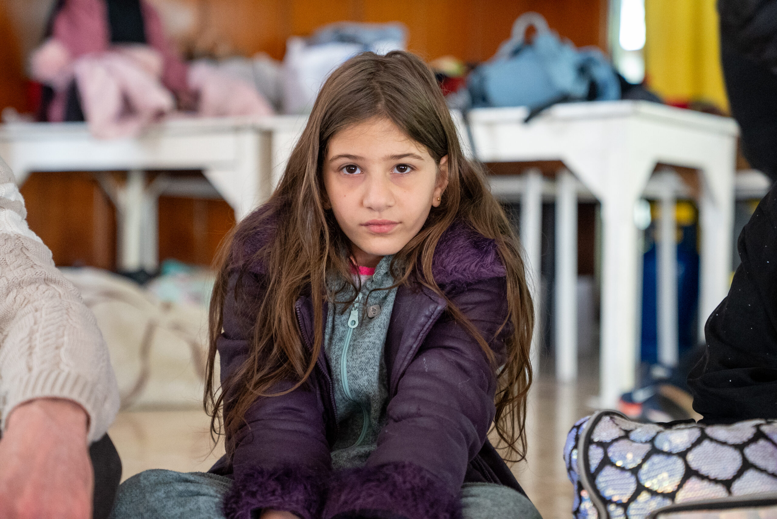 Zeinab, 12, sits in public school turned into a shelter in Lebanon. UNICEF team is on the ground providing emergency supplies including mattresses, blankets, water, hygiene, baby and dignity kits.