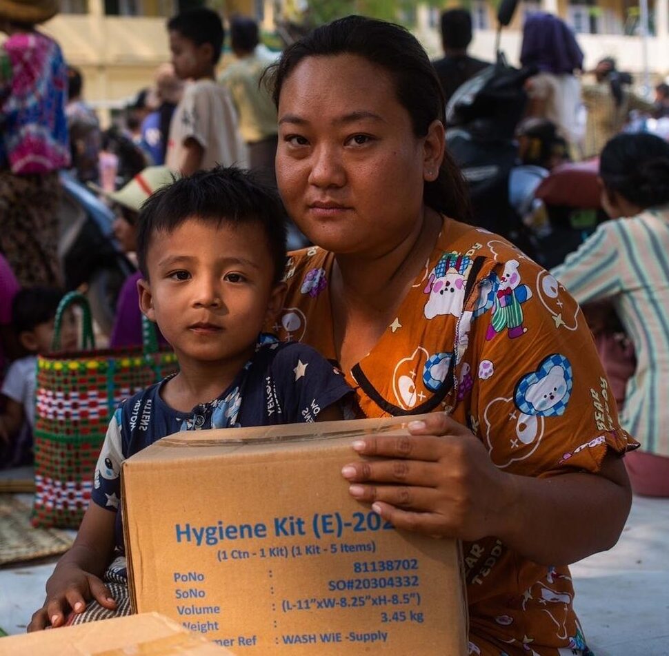 A family holding a box delivered by donations to UNICEF.