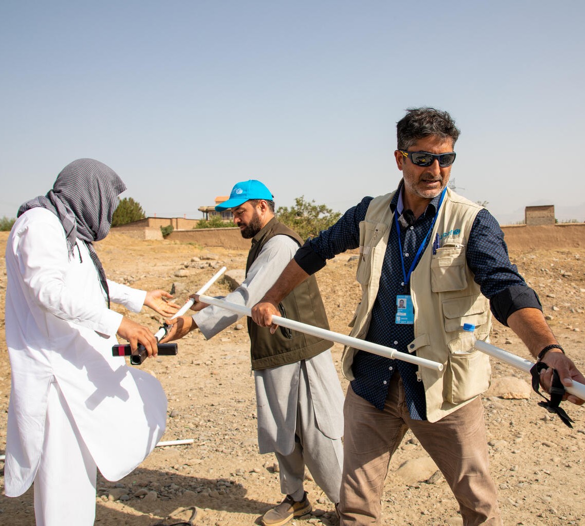 UNICEF staff work on a water project to help children.
