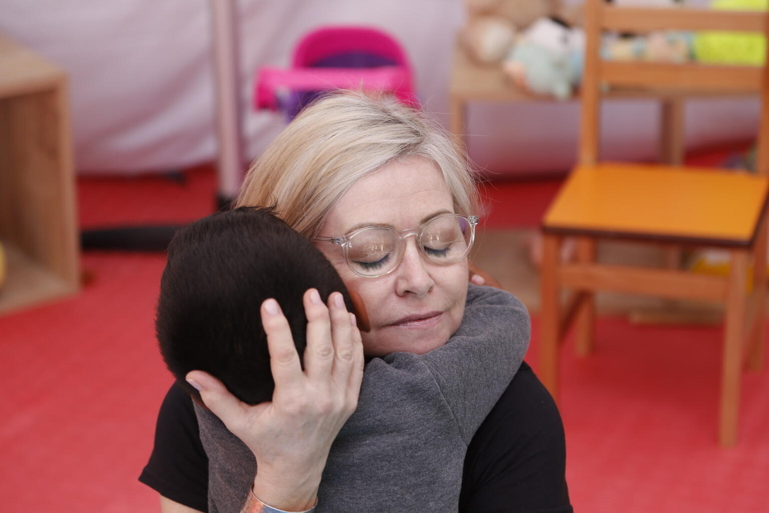 UNICEF Ambassador Cathy Kelly hugs a child,