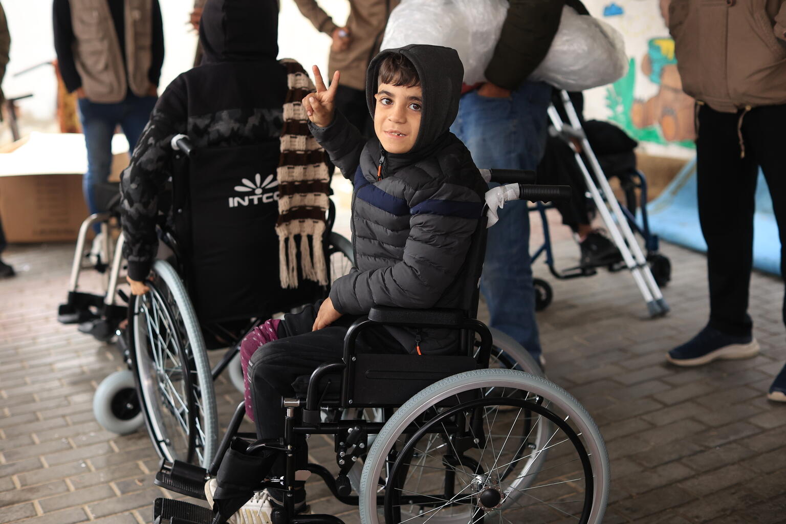 A disabled boy in Palestine in a wheelchair provided by donations to UNICEF.