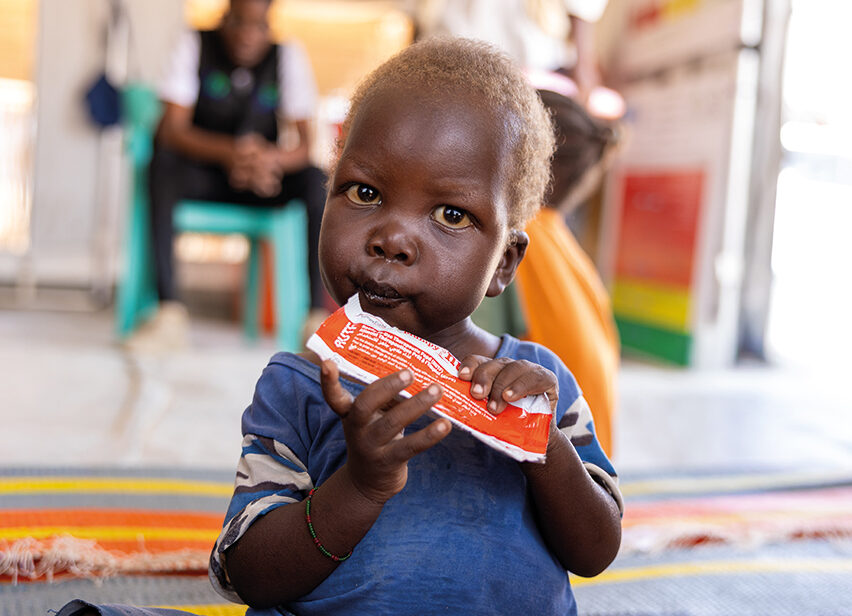 A child eating RUTF food in Sudan.